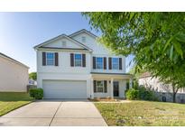 Charming two-story home with a well-manicured lawn and attached two car garage at 1430 Eastway Dr, Dallas, NC 28034