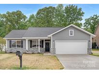 Charming single-story home with gray siding, stone accents, and a well-maintained front yard at 1706 30Th Avenue Ne Ct, Hickory, NC 28601