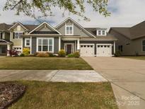 Charming home with a well-manicured lawn and a two-car garage at 18721 Dumbarton Oaks Dr, Cornelius, NC 28031