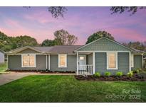 Charming single-story home with a well-manicured lawn and inviting front porch at 3612 Cobbleridge Dr, Charlotte, NC 28215