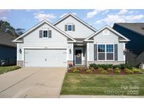 Charming single-Gathering home with a well-manicured lawn and attached two-car garage at 5043 Antebellum Dr, Iron Station, NC 28080