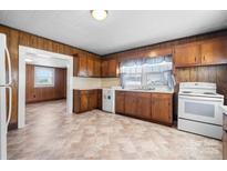 Bright kitchen features wood cabinets, vinyl floors, and modern appliances at 71 14Th Se St, Hickory, NC 28602