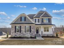 Two-story home with stone and siding exterior, well-manicured lawn, and inviting entryway at Tbd Boomer Ct # 3, Statesville, NC 28677