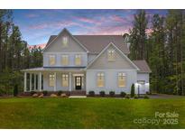 Charming two-story home with a welcoming front porch and well-manicured lawn at Tbd Boomer Ct # 3, Statesville, NC 28677
