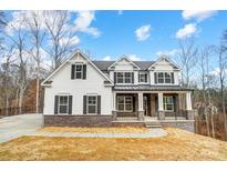 New construction home showcasing traditional architectural style, complete with stone accents and a welcoming front porch at Tbd Boomer Ct # 5, Statesville, NC 28677