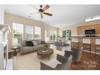 Bright living room featuring large windows, neutral tones, and an open concept design at 11544 Costigan Ln # 8306, Charlotte, NC 28277
