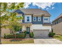 Charming two-story home with a well-maintained lawn and a two-car garage at 1226 Clingman Dr, Fort Mill, SC 29715