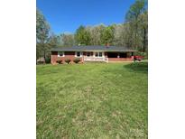 Charming single-story home with a brick exterior and a spacious front yard, perfect for outdoor activities at 215 Suncrest Rd, Cherryville, NC 28021