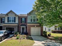 Charming two-story home with a brick facade, attached garage, and well-manicured lawn at 2268 Kensington Station Pkwy, Charlotte, NC 28210