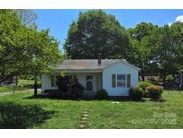 Charming single-story home with a cozy front porch and a spacious front yard at 2607 Lowell Rd, Gastonia, NC 28054