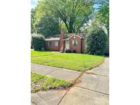 Charming one-story red brick home with a well-maintained front yard and inviting entryway at 3507 Rogers St, Charlotte, NC 28208