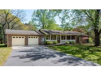 Charming brick home with a welcoming front porch and attached two-car garage at 4067 Old Buff Rd, Hickory, NC 28602