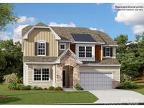 Two-story home showcasing a stone entryway, neutral siding, dark shutters, and a two-car garage at 4194 Skyboat Cir, Fort Mill, SC 29715