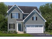 Charming two-story home with gray siding, black shutters, a two-car garage, and well-manicured landscaping at 499 Kenyon Dr, Denver, NC 28037
