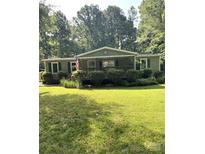 Charming one-story home with a covered porch, manicured landscaping, and an American flag at 5029 E Nc 10 Hwy Rd # 6, Catawba, NC 28609