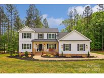 Charming two-story home with a welcoming front porch and beautifully landscaped front yard at 545 Morrison Farm Rd, Troutman, NC 28166