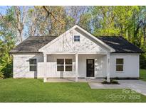 Charming single-story home with white siding, black door, and a well-manicured front lawn at 551 Belfast Dr, Gastonia, NC 28052