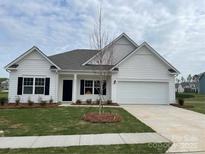 Charming single-story home with white siding, black shutters, and a well-manicured lawn at 6333 Honor Ave, Midland, NC 28107