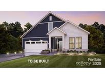 Charming two-story home with a two-car garage, covered entrance, manicured lawn and beautiful landscaping at 8105 Stillhouse Ln # 23, Harrisburg, NC 28075