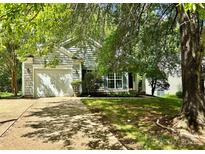 Charming single-Gathering home featuring a well-maintained front yard and a one-car garage at 8608 Warwick Crest Ln, Charlotte, NC 28215