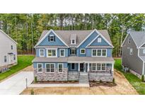 Beautiful new construction home with a stone facade and lovely blue siding at Tbd Boomer Ct # 6, Statesville, NC 28677