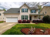Charming two-story home boasts manicured lawn, landscaping, and welcoming front porch at 1540 Coatsworth Ln, Rock Hill, SC 29732