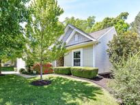 Charming home with a well-manicured lawn, mature trees, and colorful landscaping at 4143 Tullock Creek Dr, Charlotte, NC 28269