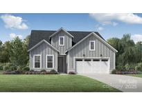 Charming craftsman-style home with gray siding, manicured lawn, and an attached two-car garage at 4158 Eastover Glen Rd # 0325, Charlotte, NC 28269