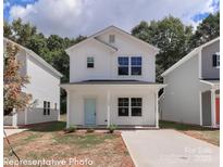 Charming two-story home with a light blue door and covered front porch at 558 Ridge Ave, Mooresville, NC 28115