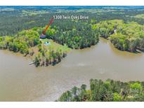 Stunning aerial view of waterfront home with a private pool on a wooded lot at 1308 Twin Oaks Dr, Chester, SC 29706