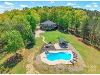 Aerial view of a large house, in-ground pool, gazebo, and lake at 1308 Twin Oaks Dr, Chester, SC 29706