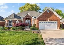 Beautiful brick home featuring an attached two-car garage and a well-maintained front lawn at 1511 Elkhart Cir, Gaston, NC 28054
