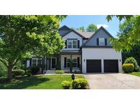 Charming two-story home featuring a two-car garage and well-manicured lawn and professionally landscaped front yard at 1811 Robbins Meadows Dr, Waxhaw, NC 28173