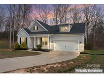Charming single-Gathering home showcasing gray siding, black shutters, and an attached two-car garage at 1870 Beth Haven Church Rd, Denver, NC 28037