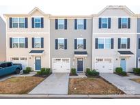 Charming townhomes with individual garages, blue doors and shutters, and well-maintained landscaping at 2051 Langer St, Charlotte, NC 28214