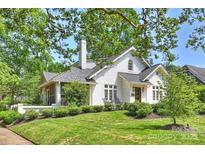 Charming white home featuring a chimney, a screened in porch, and a well-manicured lawn at 2101 Dilworth W Rd, Charlotte, NC 28203