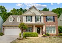 Charming two-story home with manicured lawn, traditional brick, and neutral siding at 3131 Arborhill Rd, Charlotte, NC 28270