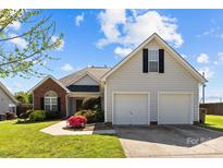 Charming home featuring a brick facade, two-car garage, and a well-manicured lawn at 4705 Granite Ct, Indian Trail, NC 28079