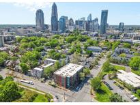 Stunning aerial view of a neighborhood near downtown with lush greenery and a glimpse of the city skyline at 626 N Graham St # 405, Charlotte, NC 28202