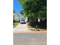 Charming two-story home with a well-maintained front yard and a private driveway leading to an attached garage at 7113 Sycamore Grove Ct, Charlotte, NC 28227