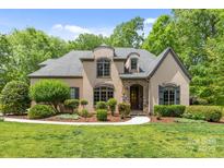 Charming home with a manicured lawn, stone accents, and a welcoming walkway at 914 Elizabeth Ln, Matthews, NC 28105