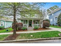 Charming two-story home with a welcoming front porch and well-maintained landscaping at 10210 Roosevelt Dr, Huntersville, NC 28078