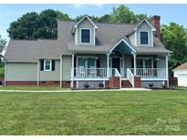Charming home with a welcoming front porch, dormer windows, and a well-maintained lawn at 1228 Quiet Acres Rd, Rock Hill, SC 29732