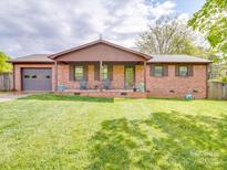 Charming brick home with a welcoming front porch and well-manicured lawn at 1315 Holshouser Rd, Rockwell, NC 28138