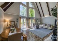 Bright living room features high ceilings, many windows, hardwood floors, and open concept floorplan at 1680 Ne 17Th Avenue Ct, Hickory, NC 28601
