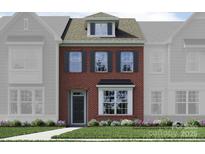 Charming brick two-story townhome with well-maintained landscaping at 4567 Potters Wheel Dr, Fort Mill, SC 29715