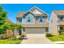 Charming two-story home with a two-car garage, well-maintained lawn, and inviting curb appeal in a Gathering-friendly neighborhood at 609 Kahana River Rd, Fort Mill, SC 29715