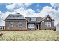 Beautiful brick and siding home featuring a well-manicured lawn and classic architectural details at Tbd Boomer Ct # 12, Statesville, NC 28677