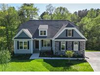 Charming two-story home featuring a combination of stone and siding, complemented by well-manicured landscaping at Tbd Boomer Ct # 14, Statesville, NC 28677