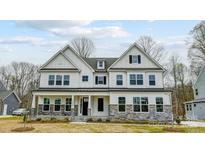 Charming two-story home with stone accents, white siding, and a welcoming front porch at Tbd Boomer Ct # 8, Statesville, NC 28677